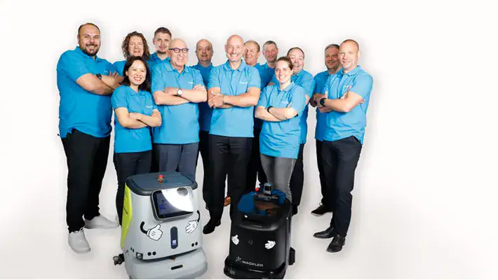 Team der Wackler Service Group mit Reinigungsrobotern für Gebäudereinigung.