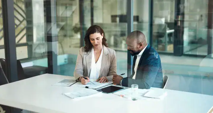 Zwei Geschäftsleute besprechen Reinigungs- und Facility-Management-Strategien.